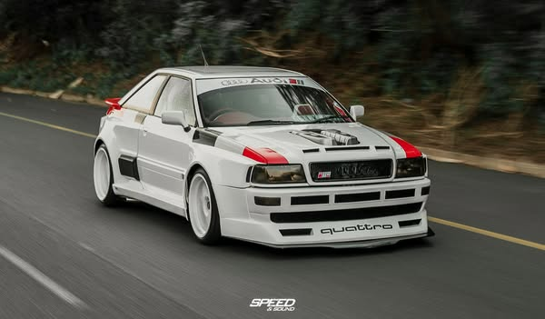 White Audi Quattro driving on AIRBFT air suspension