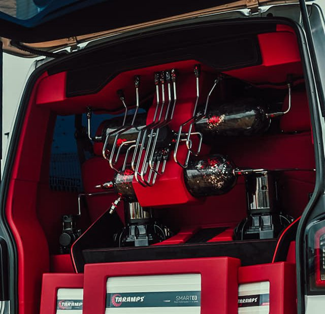 Custom red air suspension installation with tanks and hardlines
